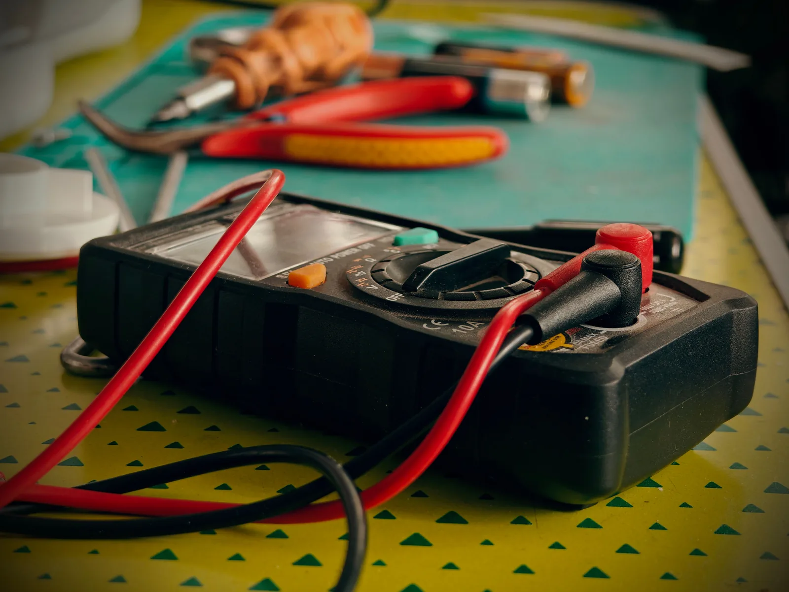 A multimeter and hand tools ready for a diagnostic visit, for electrician in Detroit