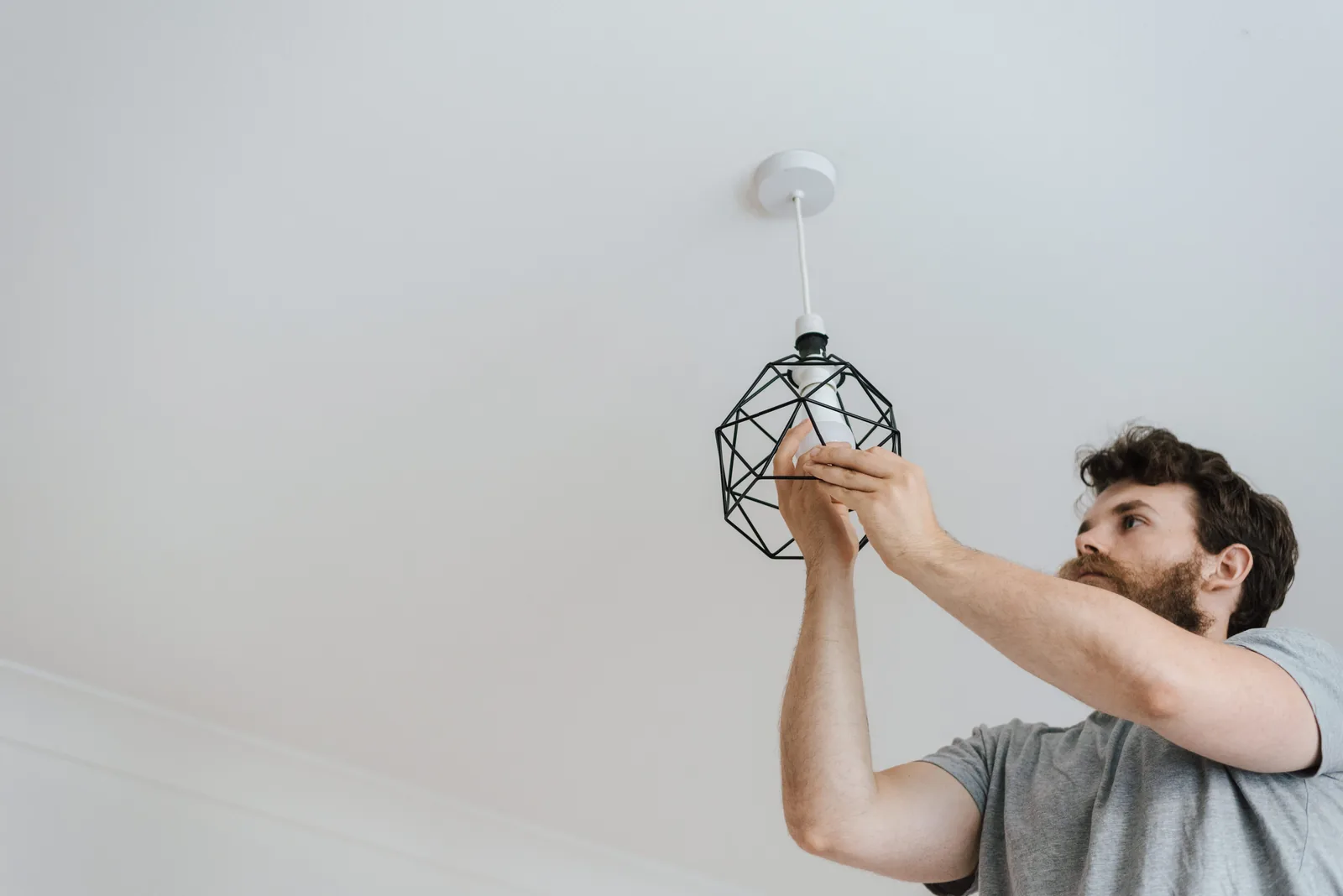 Fitting a lamp into a pendant fixture, for ev charger installation in Detroit